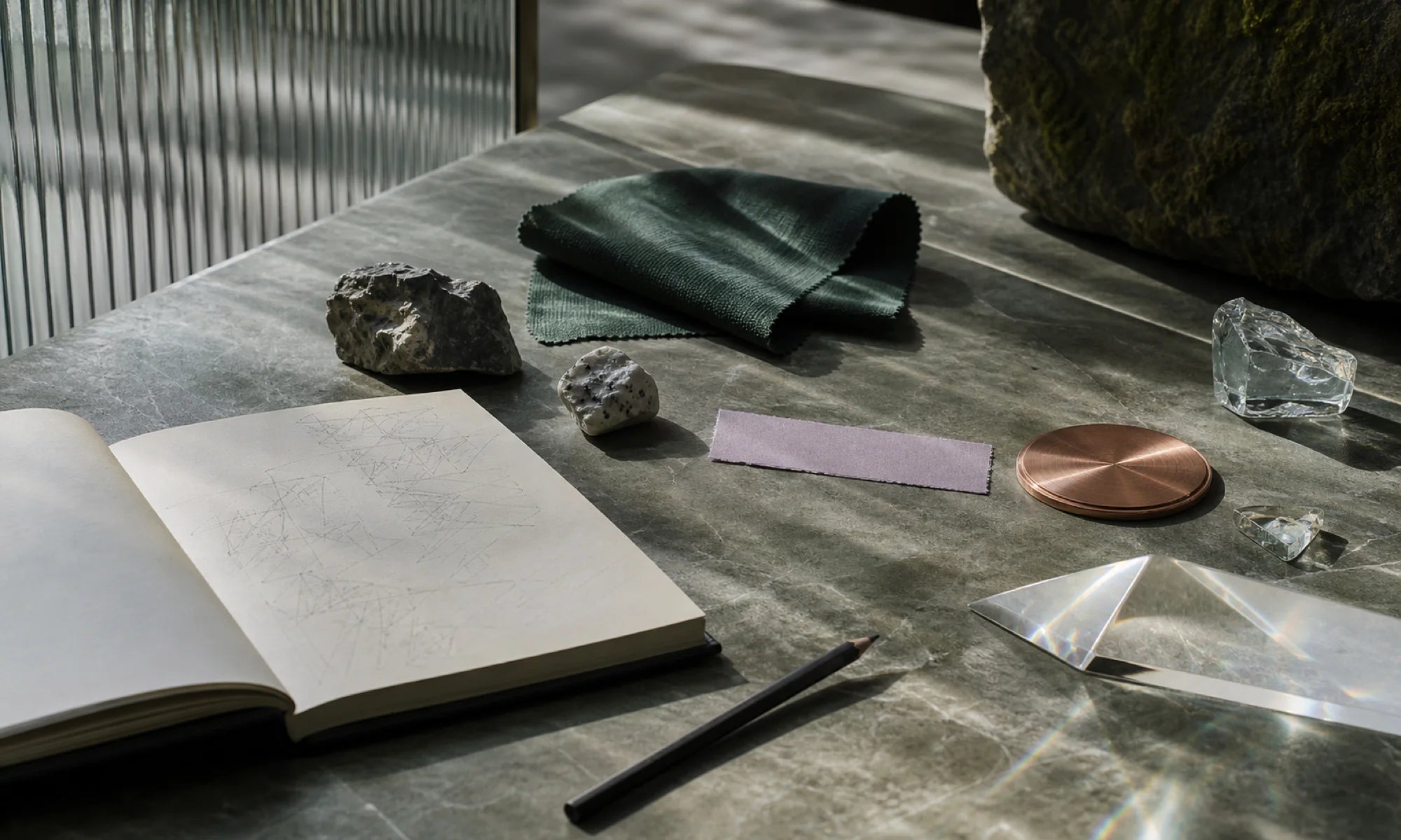 AI editorial visual: an open notebook, material swatches, glass, and stone references for a reading-space study